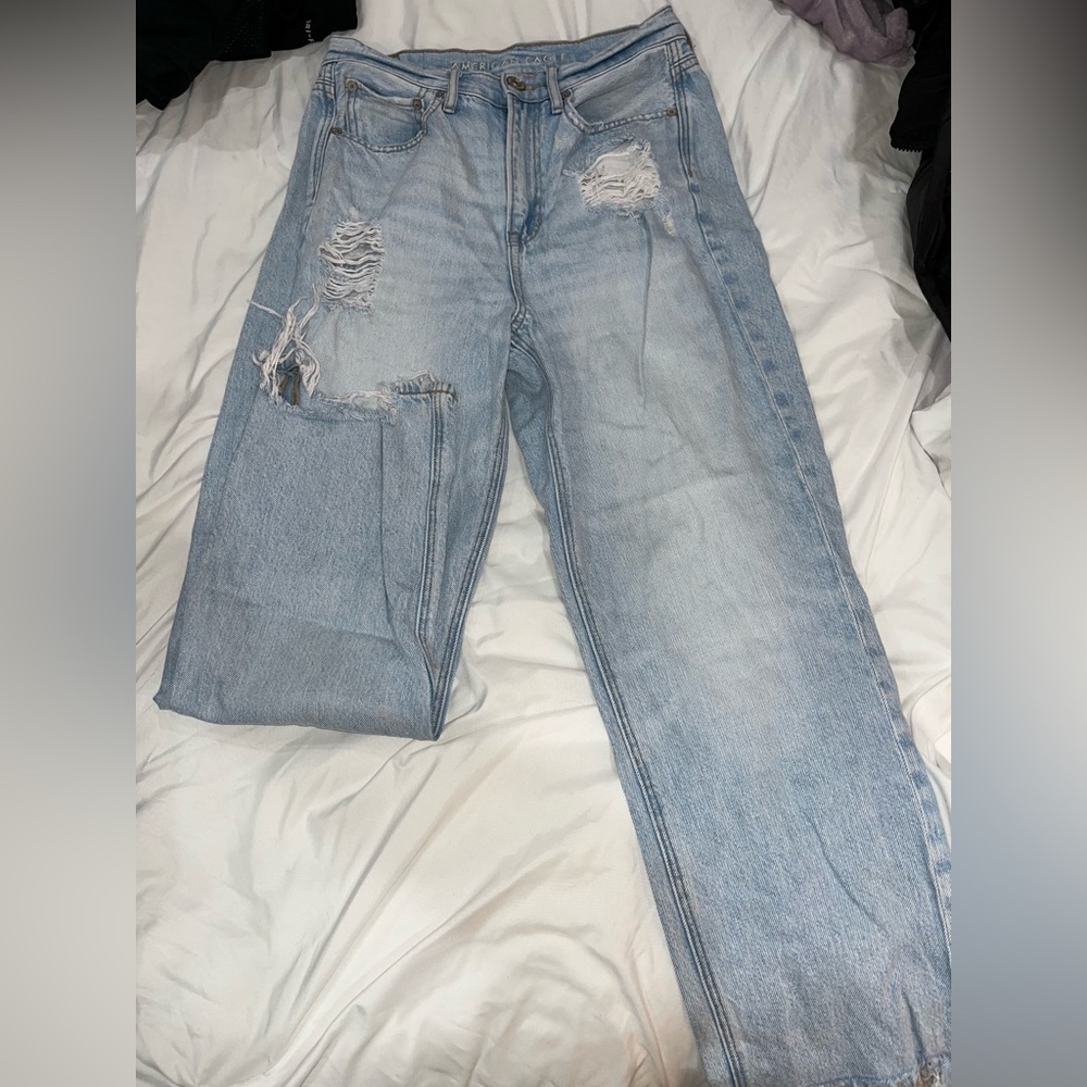 American Eagle,light wash mom blue jeans,rips towards the top and frayed bottoms